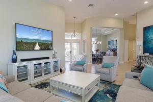 a living room with a large tv on a wall at Eagle's View in Sanibel