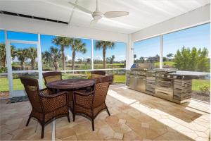 a patio with a table and chairs and a grill at Eagle's View in Sanibel
