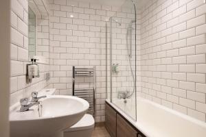 a bathroom with a sink and a toilet and a shower at The Ullswater Inn- The Inn Collection Group in Glenridding
