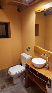 a bathroom with a toilet and a sink at Tres Vistas in San Carlos de Bariloche