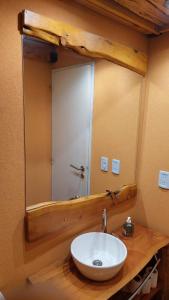 a bathroom with a sink and a mirror at Tres Vistas in San Carlos de Bariloche