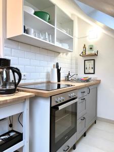 een keuken met witte kasten en een fornuis met oven bij Sali -R7-Apartmenthaus, WLAN, TV in Remscheid