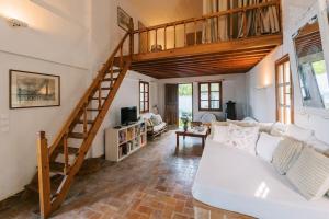 a living room with a white couch and a staircase at Villa Margarita - Ampia villa situated in Lardos in Lardos