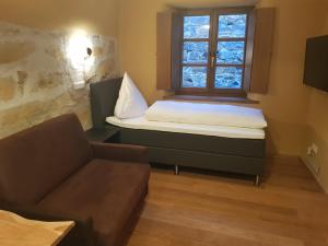 a small room with a bed and a window at Boardinghouse Stadtmauer in Schwandorf in Bayern