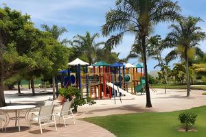 a playground with a slide in a park at Luxo a 50 m da praia, acesso ao Iberostar Resort in Praia do Forte