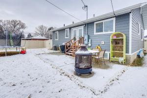 a yard with a house and a table in the snow at Billings Home with Trampoline, Gas Grill and Fire Pit! in Billings