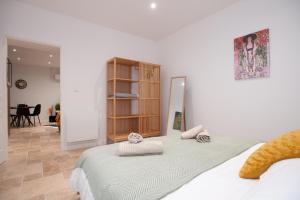 a bedroom with a bed with two pillows on it at Apparts Gambetta in Libourne +30 photos