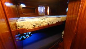 a small bed in the back of a boat at Bed & Breakfast & Sea with Captain in Pirovac