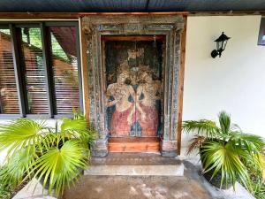 a door with a painting on the side of a building at Chamarel Mountain chalets in Chamarel