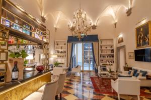 a bar with white chairs and a chandelier at Golden Tower Hotel & Spa in Florence