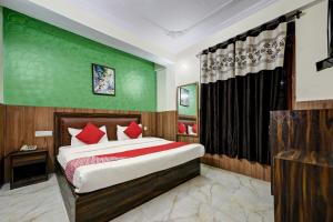 a bedroom with a bed and a green wall at Woods Imperial Kufri in Shimla