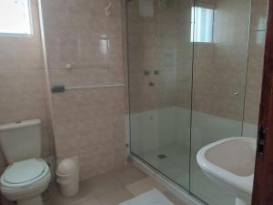 a bathroom with a shower and a toilet and a sink at La Siesta Hotel in Santa Cruz de la Sierra