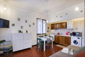 a kitchen with a table and a dining room at Una Palma a Camogli by Wonderful Italy in Camogli