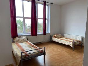 a room with two beds and a window at GASTEM UG in Berlin