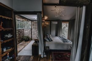 a bedroom with a bed in a room with a window at Casablanca Villas CB in Brumadinho