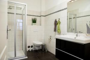a bathroom with a sink and a toilet and a shower at Villa Zur Alten Post in Kühlungsborn