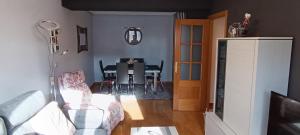 a living room with a table and a dining room at Piso céntrico al lado de Oviedo in Lugones