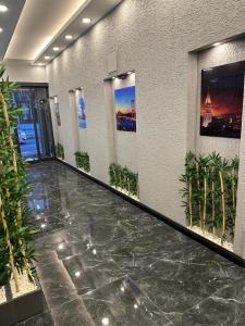 a lobby with a marble floor and pictures on the walls at Emsa Otel Maltepedeki Eviniz in Istanbul
