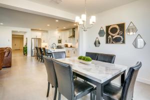 a kitchen and dining room with a table and chairs at Newly Built Glendale Home 5 Mi to Westgate! in Glendale