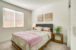 a bedroom with a large bed and a window at Newly Built Glendale Home 5 Mi to Westgate! in Glendale