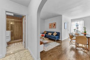 a living room and dining room with a blue couch at Stylish 2Bd in Brooklyn Heights in Brooklyn