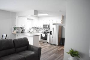 a living room with a couch and a kitchen at Arctic 415 in Grand Rapids