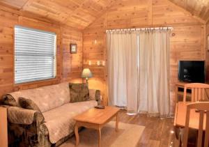 a living room with a couch and a table at Cozy 1BR Cabin in Jacksonville in Jacksonville