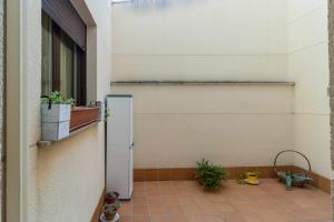 a refrigerator in the corner of a building with potted plants at El Palomarcico in Zamora