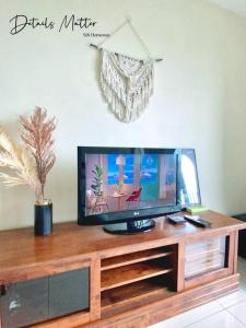 a tv sitting on top of a wooden entertainment center at GreeneryHome 1-4pax Trefoil Studio Setia Alam in Shah Alam