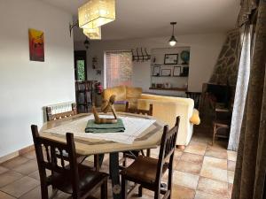 a dining room with a table with a dog statue on it at Casa Rurales El Nido in La Serrada