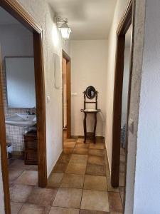 a hallway leading to a bathroom with a sink at Casa Rurales El Nido in La Serrada