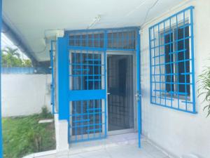 una porta blu sul lato di una casa di louis LBV a Libreville
