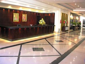 a lobby of a hotel with a reception desk at Pyramisa Sunset Pearl Apartments in Hurghada