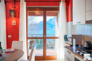 a kitchen with a door open to a balcony at THE LOFT by Design Studio in Bellano