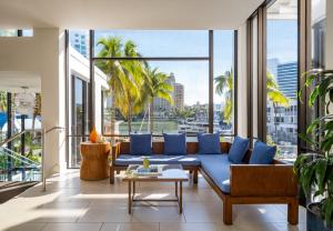 a living room with a blue couch and a large window at Hyatt Regency Sarasota in Sarasota