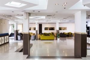 a lobby with couches and chairs in a building at מלון המלך שאול in Ashkelon