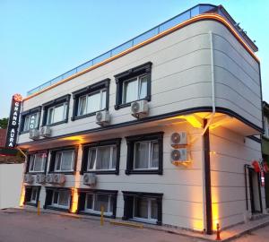 a large white building with windows on a street at GRANDAURA EDıRNE in Edirne