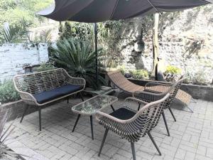 a group of chairs and an umbrella on a patio at Town House in the North Laines in Brighton & Hove