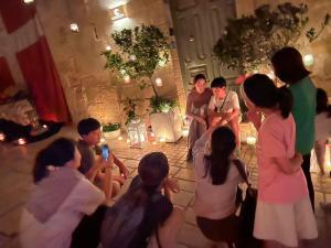 a group of people standing around in a room at Casa Cara in Birgu