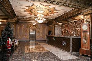 a lobby with a christmas tree and a chandelier at Bey Hotel Baku in Baku