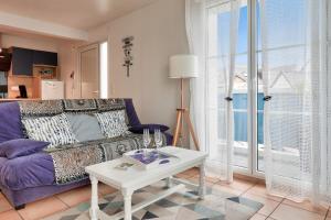sala de estar con sofá púrpura y mesa en Vacances iodees a Sarzeau, en Sarzeau