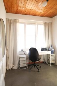 Zimmer mit einem Schreibtisch und einem Stuhl vor einem Fenster in der Unterkunft Furnished - Bright, Modern apartment in Brussels, 15 minutes walk from the Atomium in Brüssel