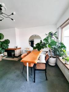 un comedor con mesa y algunas plantas en Furnished - Bright, Modern apartment in Brussels, 15 minutes walk from the Atomium, en Bruselas