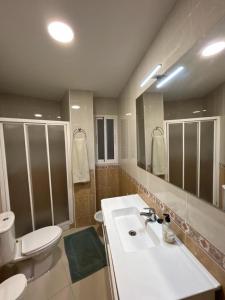 a bathroom with a sink and a toilet and a mirror at Aprt. Con vistas Foro Romano in Cartagena