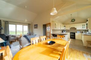 a kitchen and living room with a wooden table at Tigh Gwen in Ballyferriter