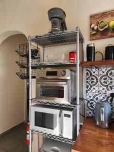 a kitchen with two microwaves on a rack at Ti Brico Gros Islet Bungalow in Gros Islet