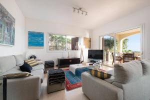 a living room with two couches and a tv at Villa Bendinat 10 in Calvia Town