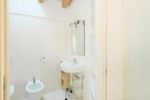 a white bathroom with a sink and a toilet at A Casa Di Maria in Como