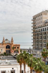 a view of a city with palm trees and buildings at Just Here apartments - La mansarda in Bari