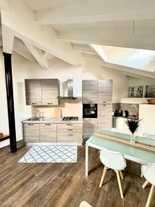 a kitchen with a table and chairs in a room at [Bridge Apt.] Garage - Netflix - wifi in Brescia